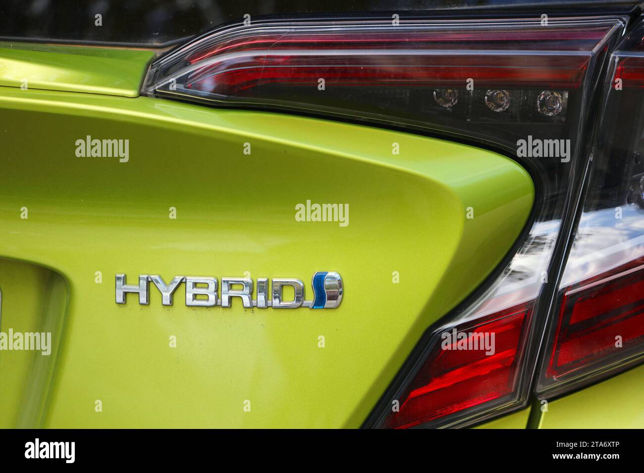 BARCELONA, SPAIN - OCTOBER 7, 2021: Hybrid marking on a Toyota car in Spain. Modern hybrid cars are partially powered by electricity. Stock Photo