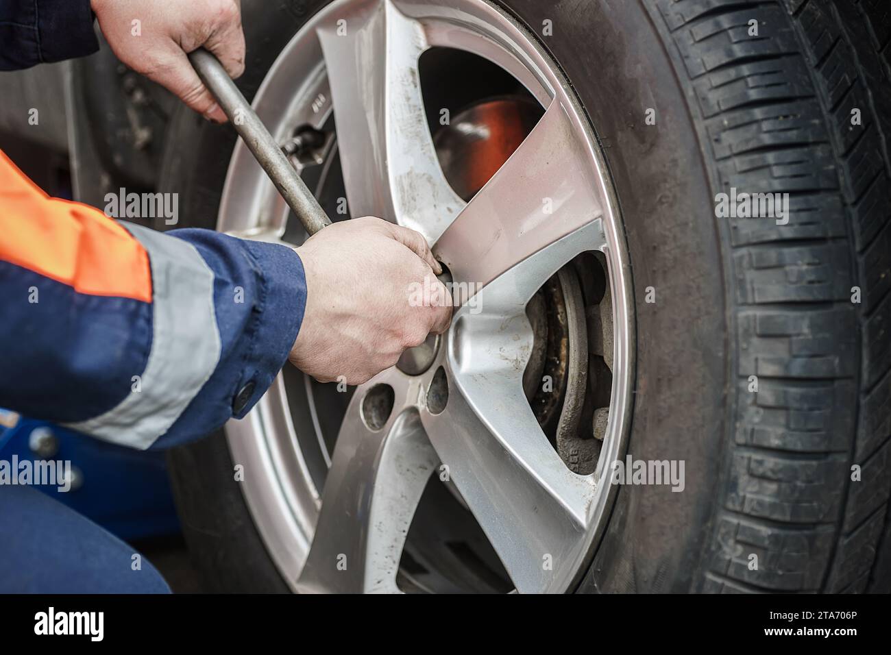 Car wheel replacement. Self-service tire fitting concept. Installing a new wheel. Winter and summer car tyres. Stock Photo