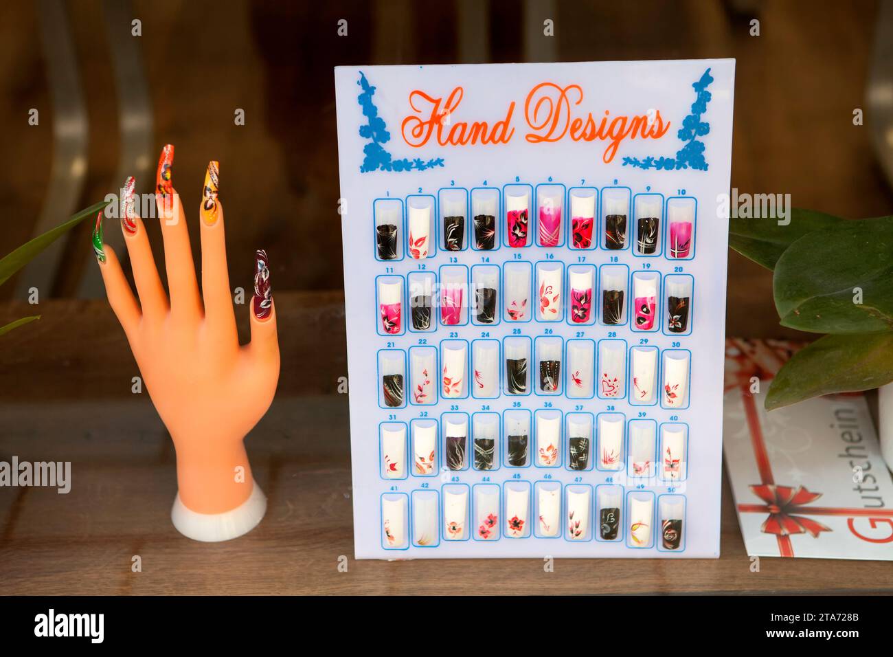 Decoration at a display window of a nail salon, Germany Stock Photo