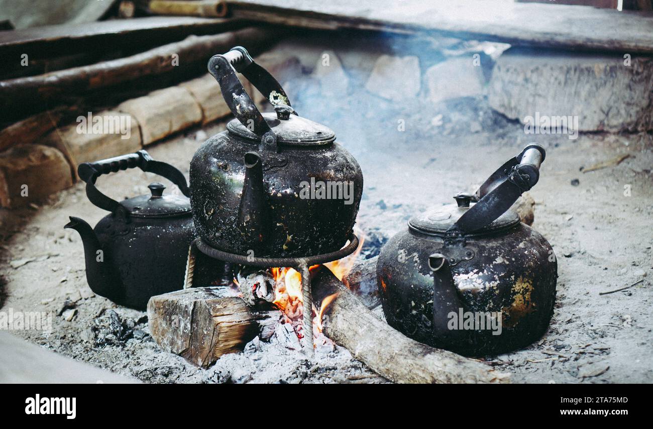 https://c8.alamy.com/comp/2TA75MD/coffee-pot-on-campfire-kettle-is-heated-on-a-bonfire-outdoor-recreation-concept-close-up-boil-water-old-kettle-on-the-fire-with-a-charcoal-stove-at-2TA75MD.jpg