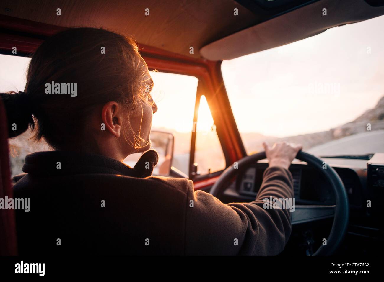 Young man driving man at sunset on vacation Stock Photo