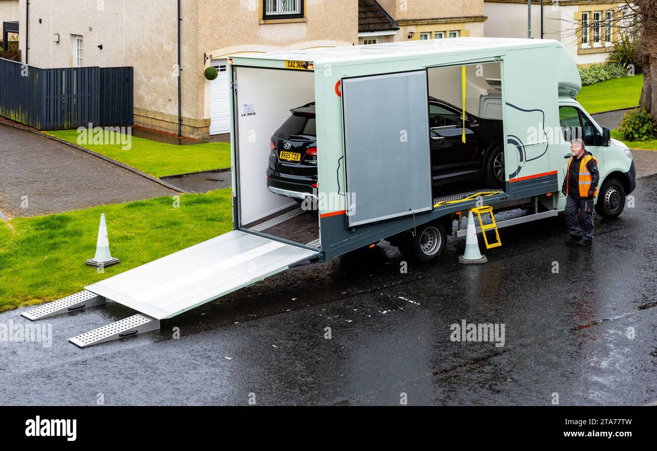black SUV car being delivered to a private home address by a Luton