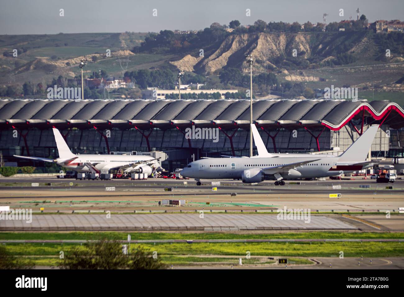 Planes transiting the runways near one of the terminals of Madrid Barajas airport Stock Photo