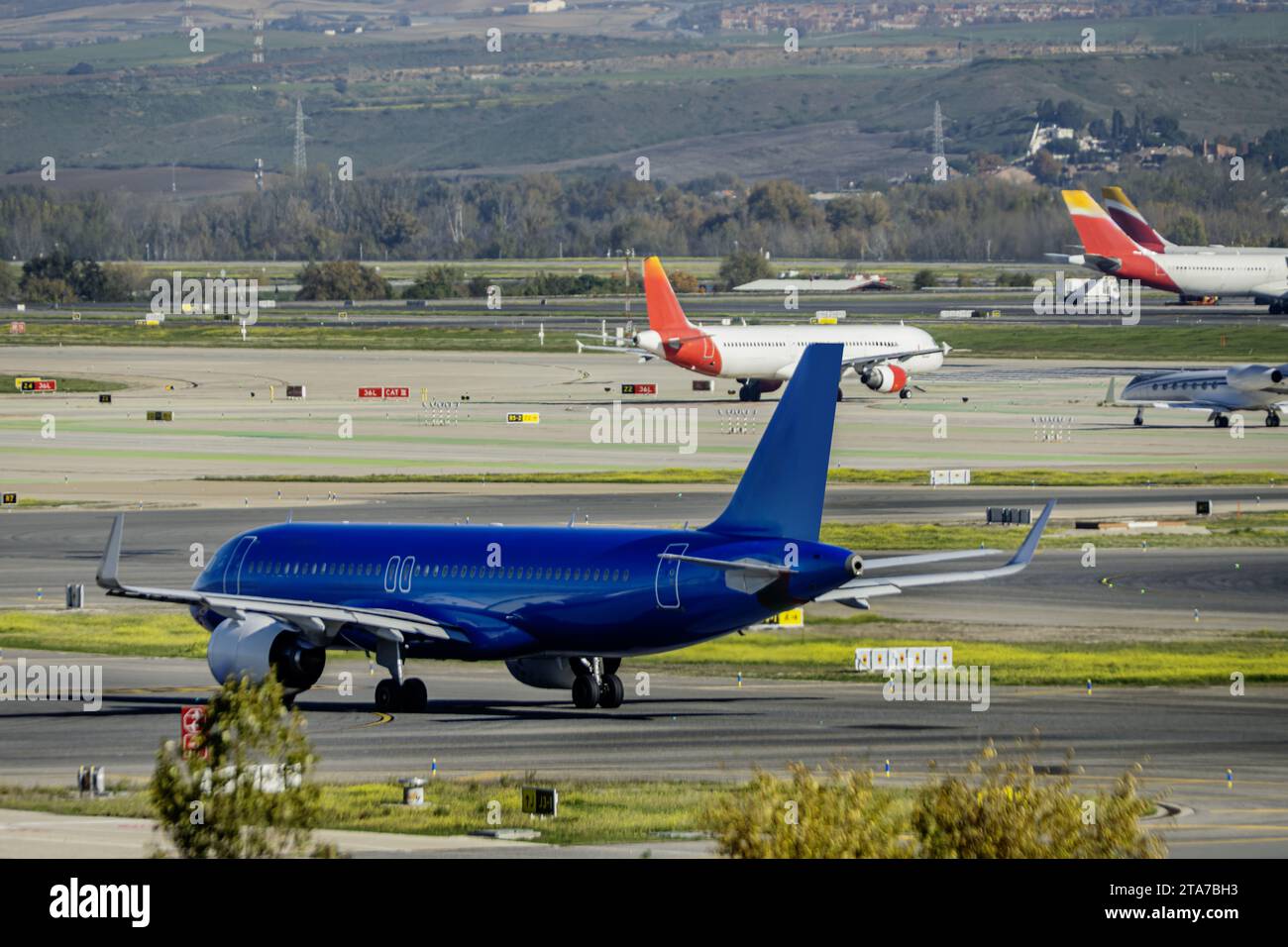A blue airplane transiting the access runways Stock Photo