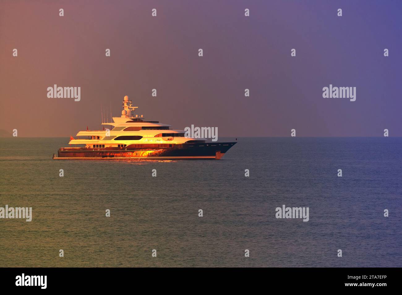 70m charter superyacht Martha Ann at anchor at sunset. Stock Photo