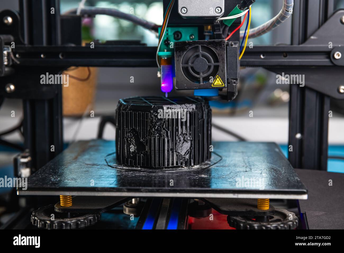 A 3D printer prints a black model. Technology at home Stock Photo