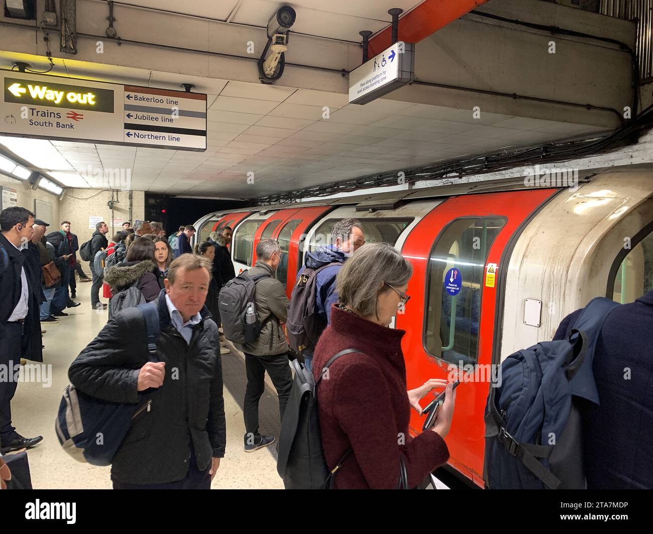 London, UK. 28th November, 2023. Commuters and passengers wait for a London Underground tube at Waterloo Railway Station in London to Bank Underground Station. The Waterloo & City train had to return to the depot causing passenger delays. Credit: Maureen McLean/Alamy Stock Photo