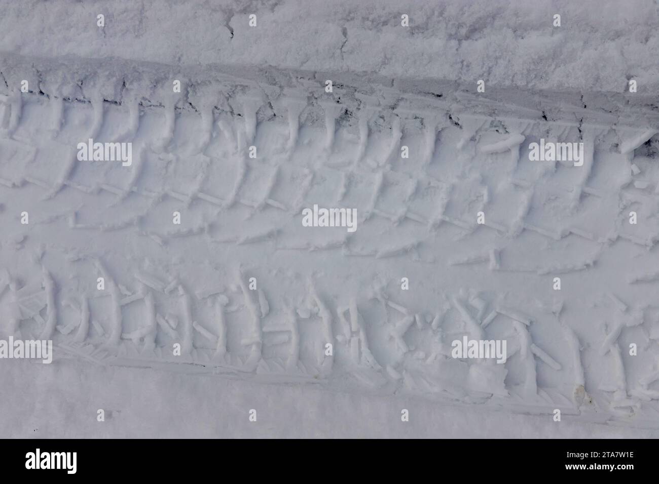 Winter trail from a car wheel in the snow, close-up. Stock Photo