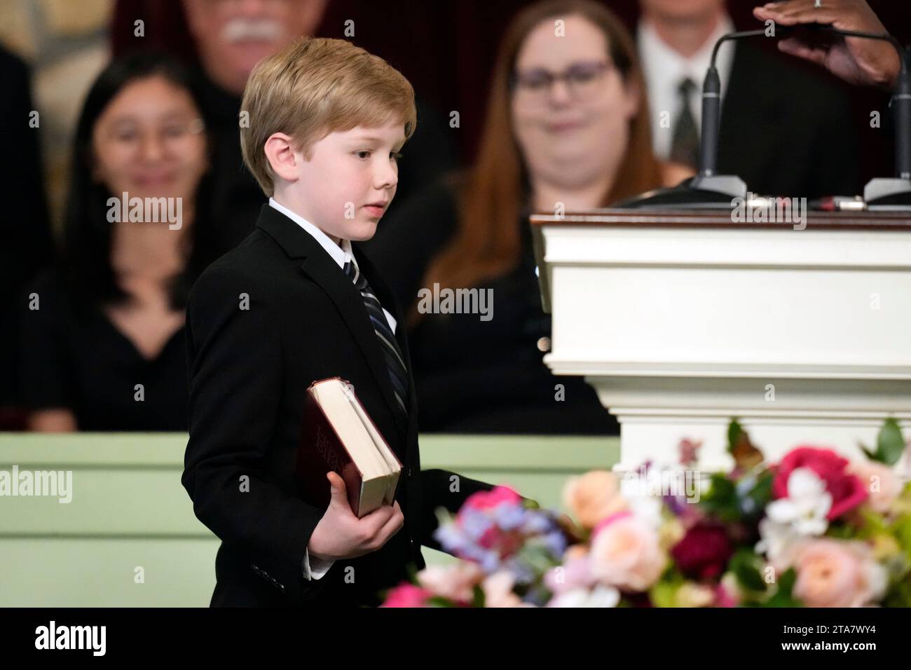 Great grandchild Charles Jeffrey Carter walks with a Bible to read a