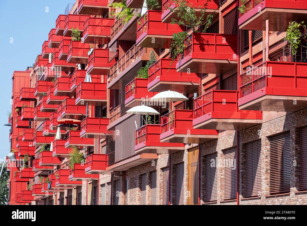 New red apartment building with balconies seen in Berlin, Germany Stock Photo