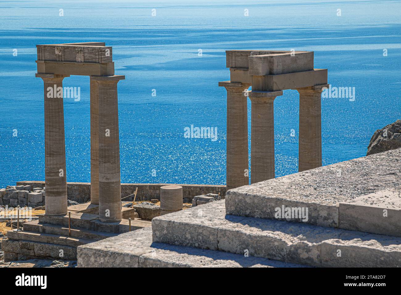 Ruins of ancient Temple of Athena Lindia on Acropolis of Lindos, built in the 4th century BC in amphiprostyle with four Doric columns at the front and Stock Photo