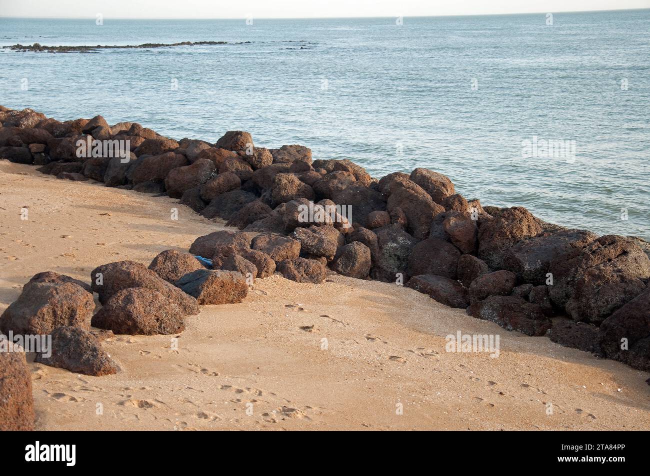 At the beach, Saly-Portudal, Petite Côte of Senegal, Senegal.  Beach, rocks; Atlantic Ocean Stock Photo