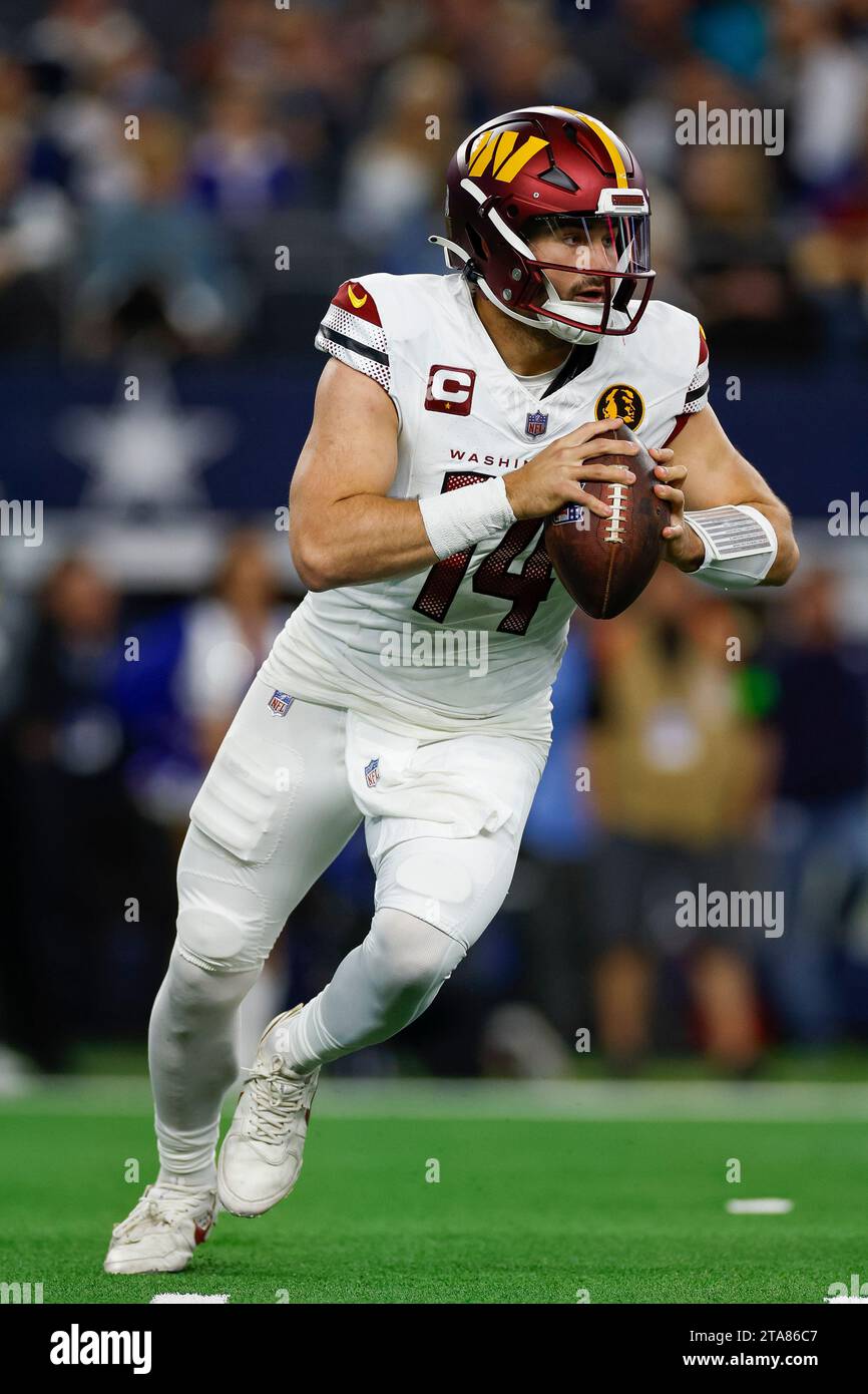 Washington Commanders quarterback Sam Howell 14 rolls out to pass