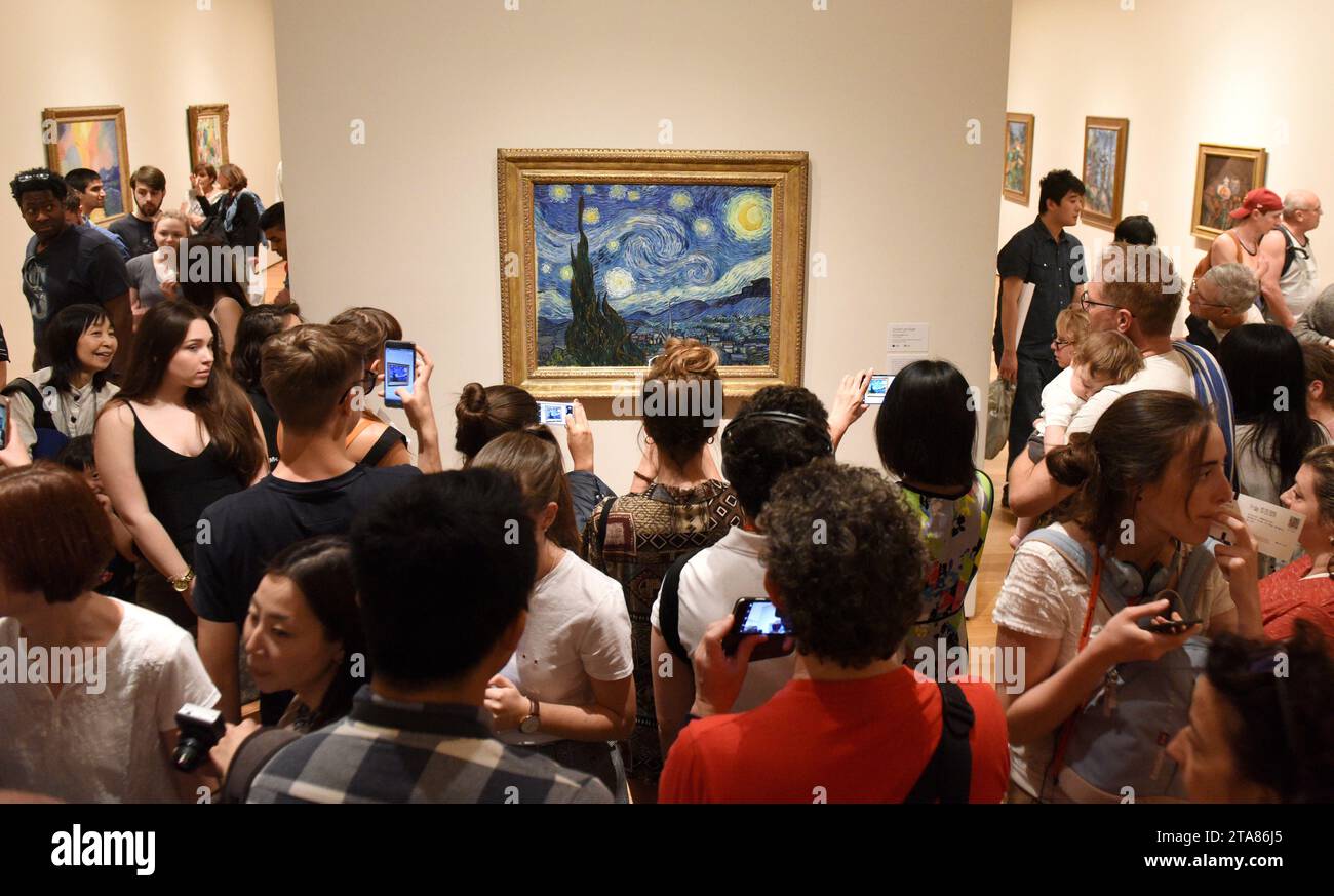 New York, USA - May 25, 2018: Crowd of people near the Starry Night by Vincent van Gogh painting in Museum of Modern Art in New York City. Stock Photo