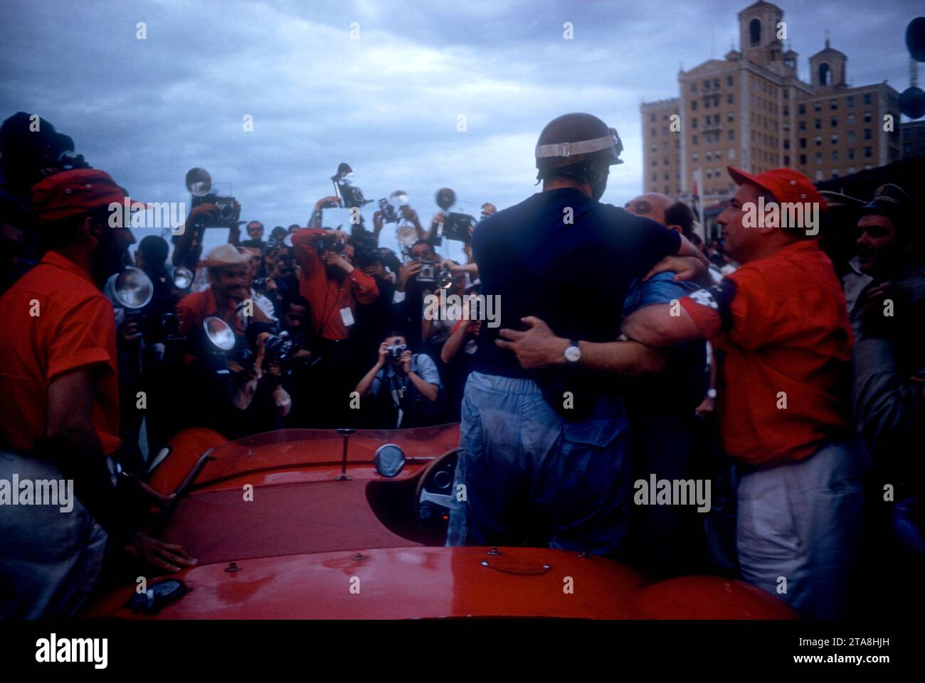 HAVANA, CUBA - FEBRUARY 24:  Juan Manuel Fangio (1911-1995) driver of the Maserati 300S climbs out of his car after the 1957 Cuban Grand Prix on February 24, 1957 in Havana, Cuba.  Fangio won the race.  (Photo by Hy Peskin) *** Local Caption *** Juan Manuel Fangio Stock Photo