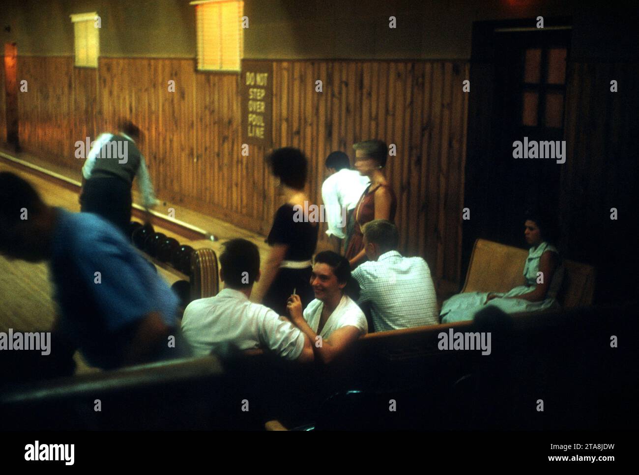 1955 General view of men and women smoking as they bowl for fun at a bowling alley circa 1955
