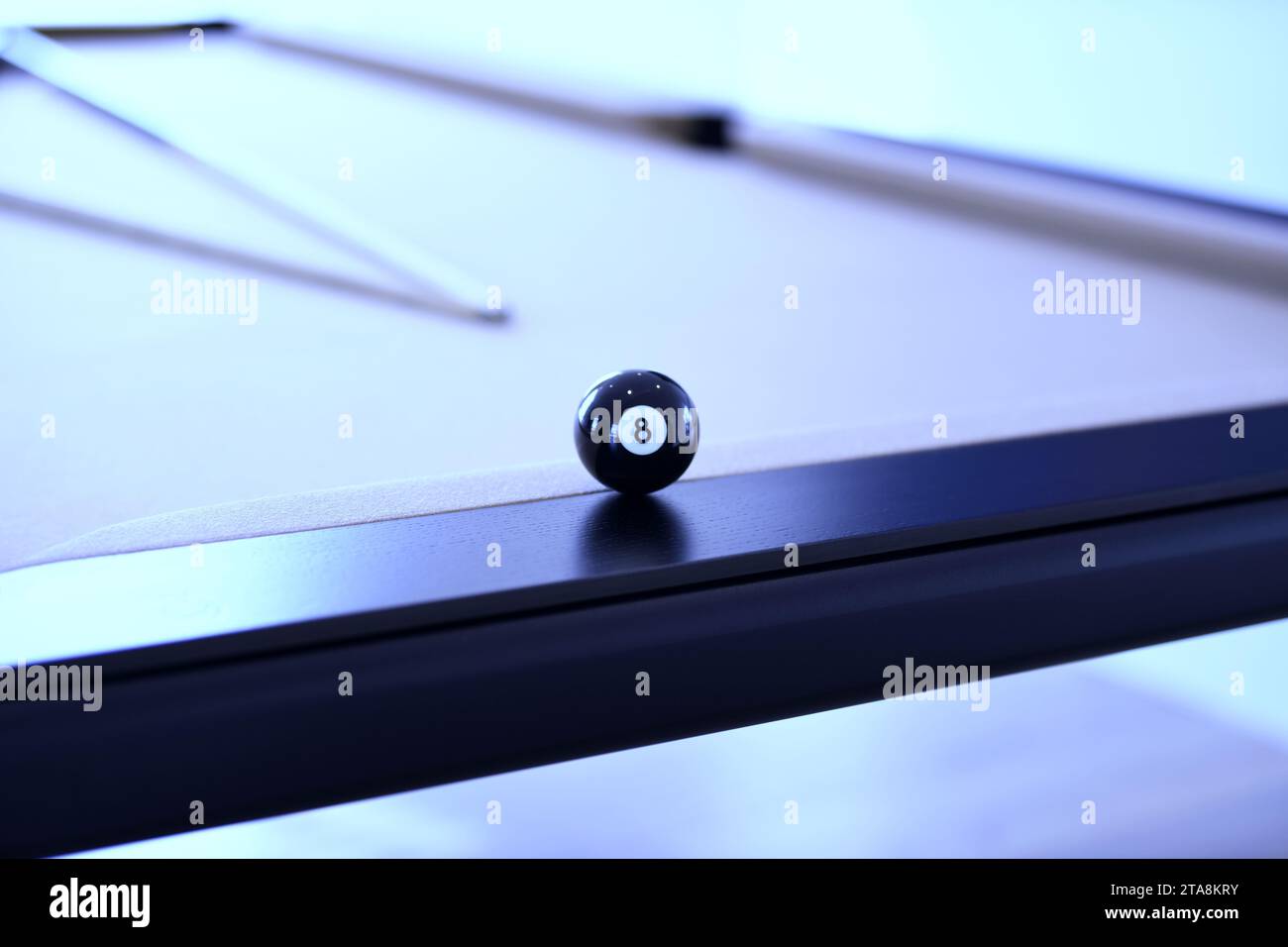 Close up of black billiard ball number eight on a pool table Stock Photo