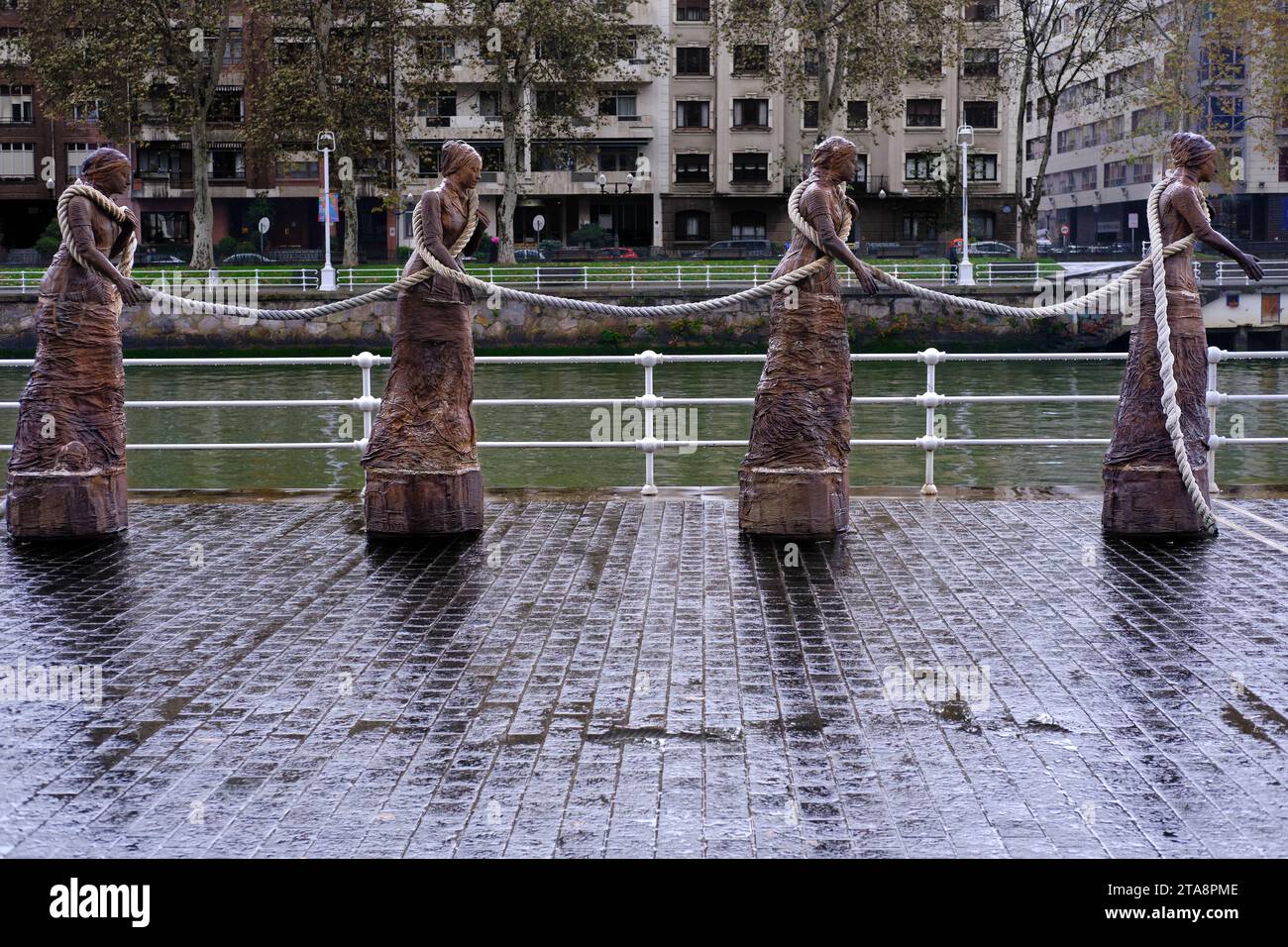 The sirgueras of Bilbao, a sculpture dedicated to women boat tugs located next to the Nervión River as it passes through the city of Bilbao. Stock Photo