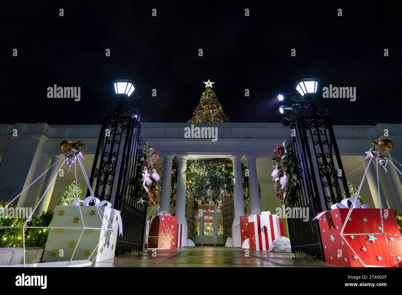 Washington, United States. 26th Nov, 2023. A giant Christmas Tree pierces through the façade of the East Wing surrounded by giant wrapped gift boxes as part of the decorations at the annual White House Christmas, November 28, 2023 in Washington, DC The theme is “Magic, Wonder and Joy,” and will welcome approximately 100,000 visitors during the holiday season. Credit: Katie Ricks/White House Photo/Alamy Live News Stock Photo