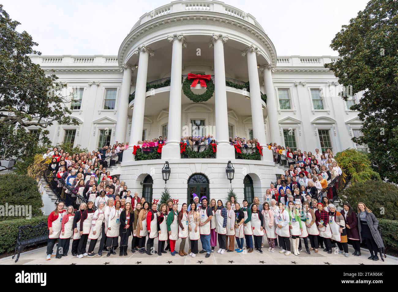 Washington, United States. 26th Nov, 2023. Volunteers pose for a group photo on the South Portico of the White House after completing the holiday décor for the annual White House Christmas, November 28, 2023 in Washington, DC The theme is “Magic, Wonder and Joy,” took 300 volunteers a week to create using 98 Christmas trees, 34,000 ornaments, 72 wreaths and about 142,000 holiday lights. Credit: Katie Ricks/White House Photo/Alamy Live News Stock Photo