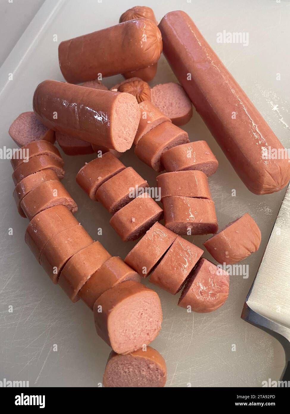Close-up of sliced ballpark hotdogs on a cutting board in a residential kitchen, 2023, USA Stock Photo