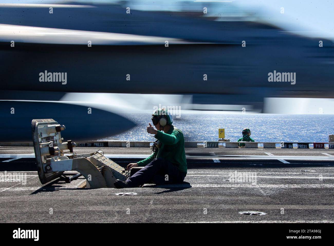 Oct 16, 2023 - Mediterranean Sea - Aviation Boatswain's Mate (Equipment) 3rd Class Jozuah Ramirez, from New Braunfels, Texas, assigned to the air department of the worlds largest aircraft carrier USS Gerald R. Ford (CVN 78), launches an F/A-18F Super Hornet, attached to the Blacklions of Strike Fighter Squadron (VFA) 213 on the flight deck, Oct. 16, 2023. Gerald R. Ford is the U.S. Navy's newest and most advanced aircraft carrier, representing a generational leap in the U.S. Navy's capacity to project power on a global scale. The Gerald R. Ford Carrier Strike Group is currently operating in th Stock Photo
