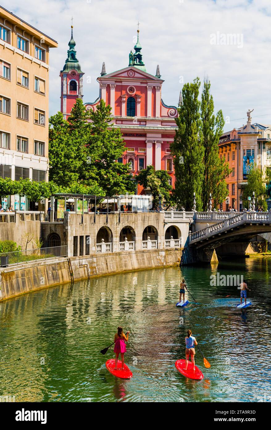 People with paddleboards on local river, Ljubljana, Slovenia Stock Photo