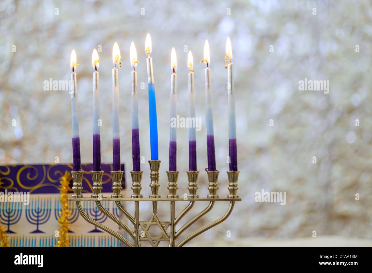 Hanukkiah Menorah candle is lit during traditional celebration of