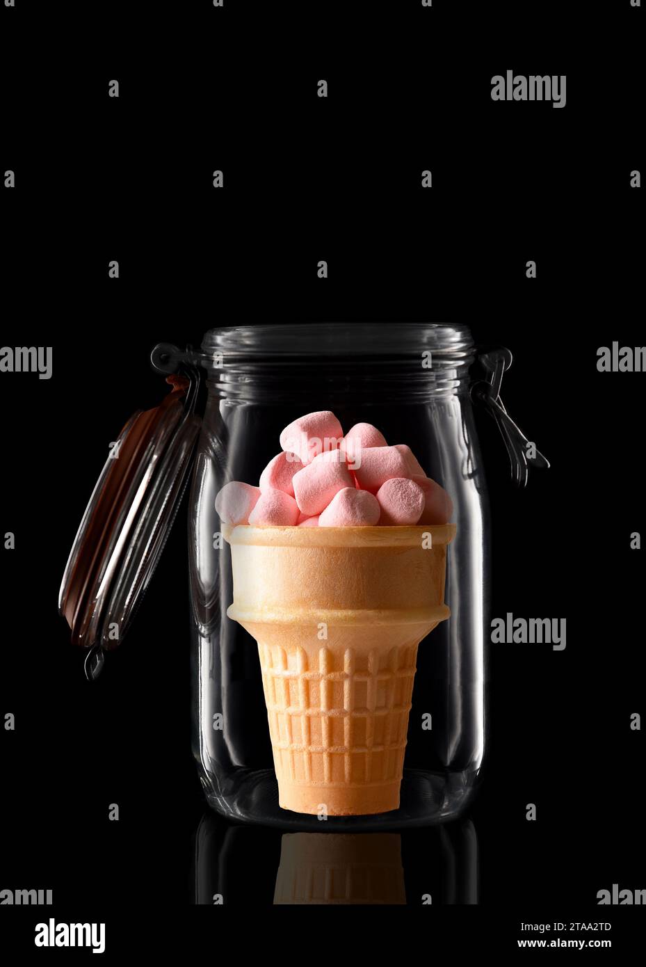 An Ice Cream Cone filled with Marshmallows in a glass storage or