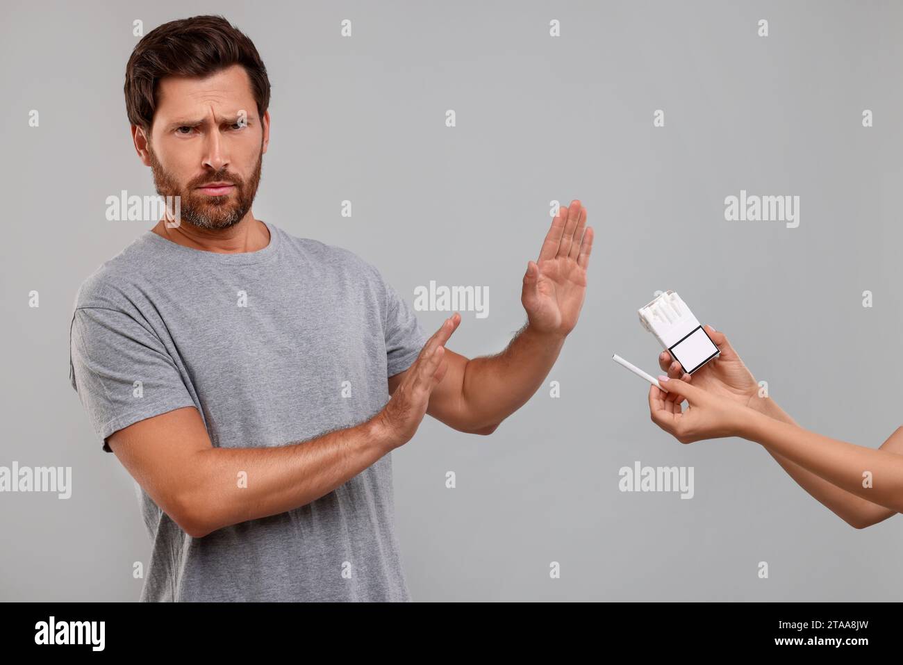 Stop smoking concept. Man refusing cigarettes on grey background Stock ...
