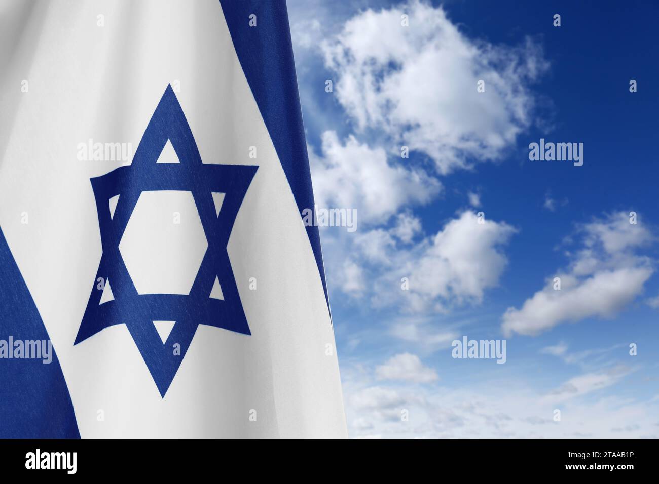 National flag of Israel against blue sky with clouds Stock Photo - Alamy