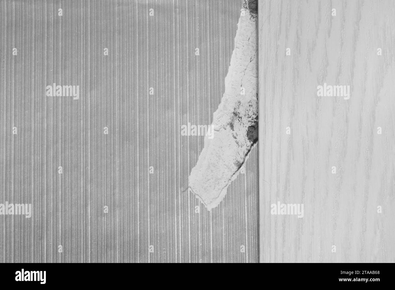 Torn broken old damage piece grey wallpaper paper object item in need of repair. Stock Photo