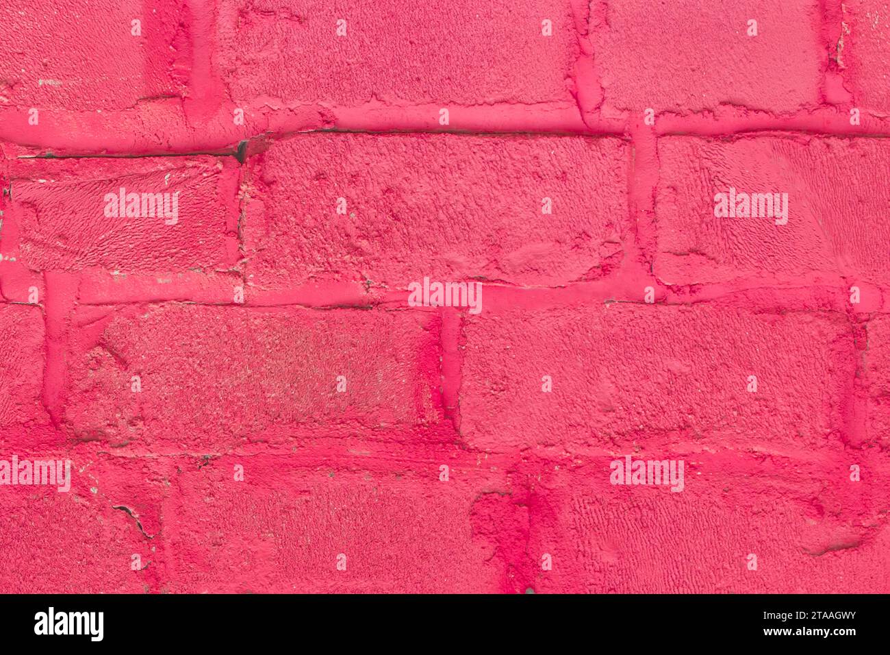 Red and pink paint on silicate blocks, brick wall, old texture, background, close-up. Stock Photo