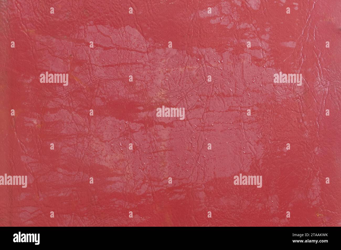 Wet water surface of red leather streaks background texture stain Stock