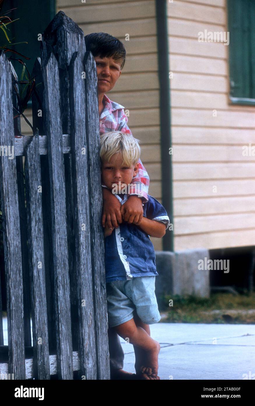 GREEN TURTLE CAY, ABACO, BAHAMAS - APRIL 28: General view of two young boys looking on near a fence on April 28, 1956 in Green Turtle Cay, Abaco, Bahamas. (Photo by Hy Peskin) Stock Photo