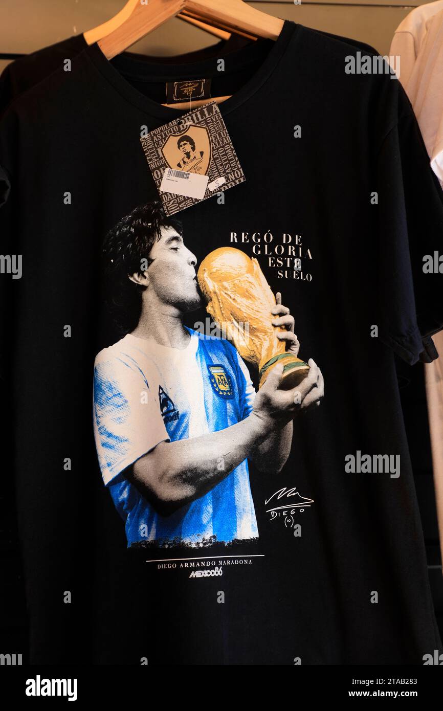 Souvenir t-shirt with image of Diego Maradona kissing FIFA World Cup trophy for sale in a souvenir store.Buenos Aires.Argentina Stock Photo