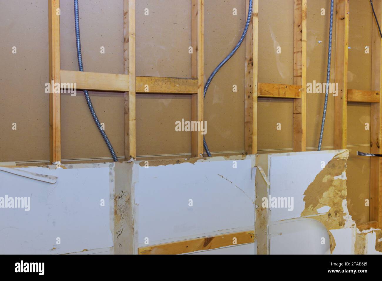 Removal of old, damaged plasterboard drywall during house