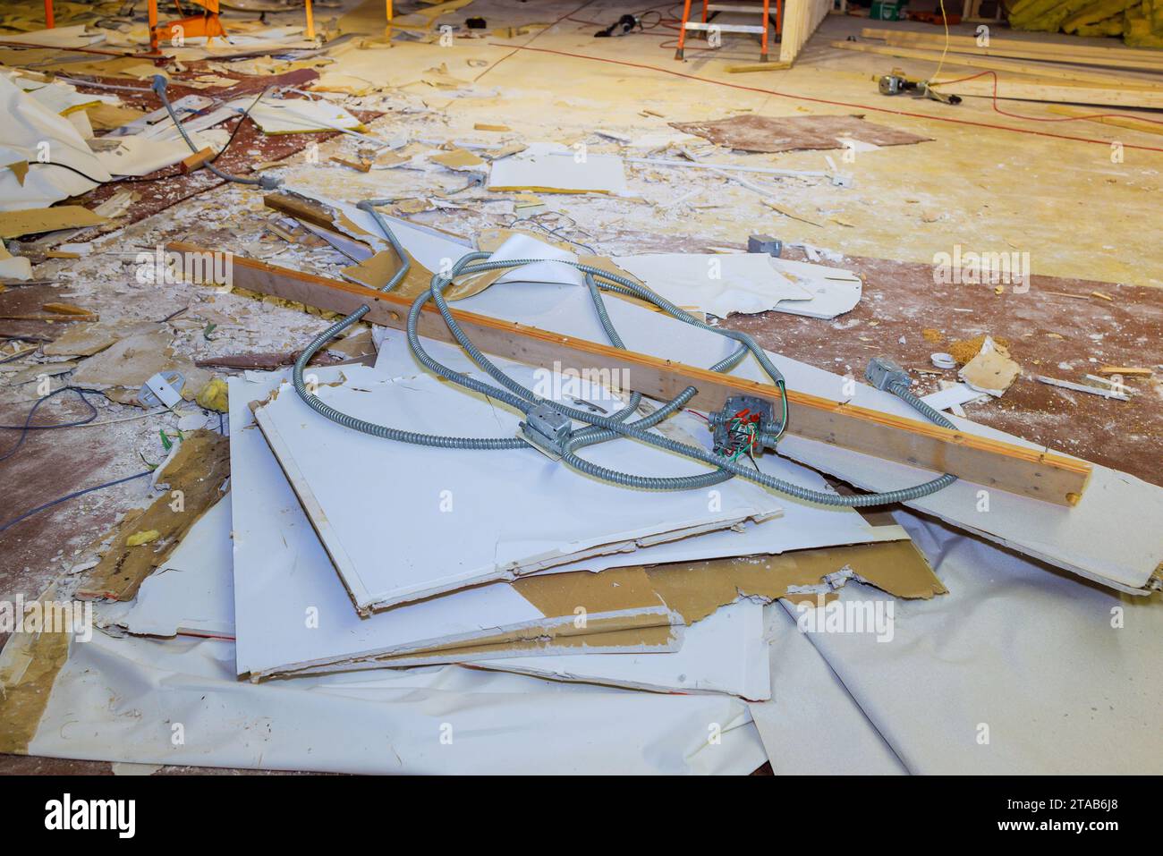 Dismantling damaged plasterboard drywall during reconstruction of home