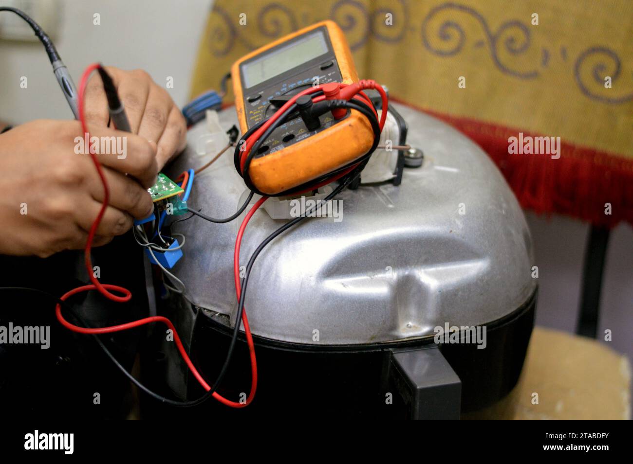 Cairo, Egypt, November 7 2023: an air fryer maintenance, repair, An air fryer is a small convection fan-assisted oven, does the same thing as deep fry Stock Photo