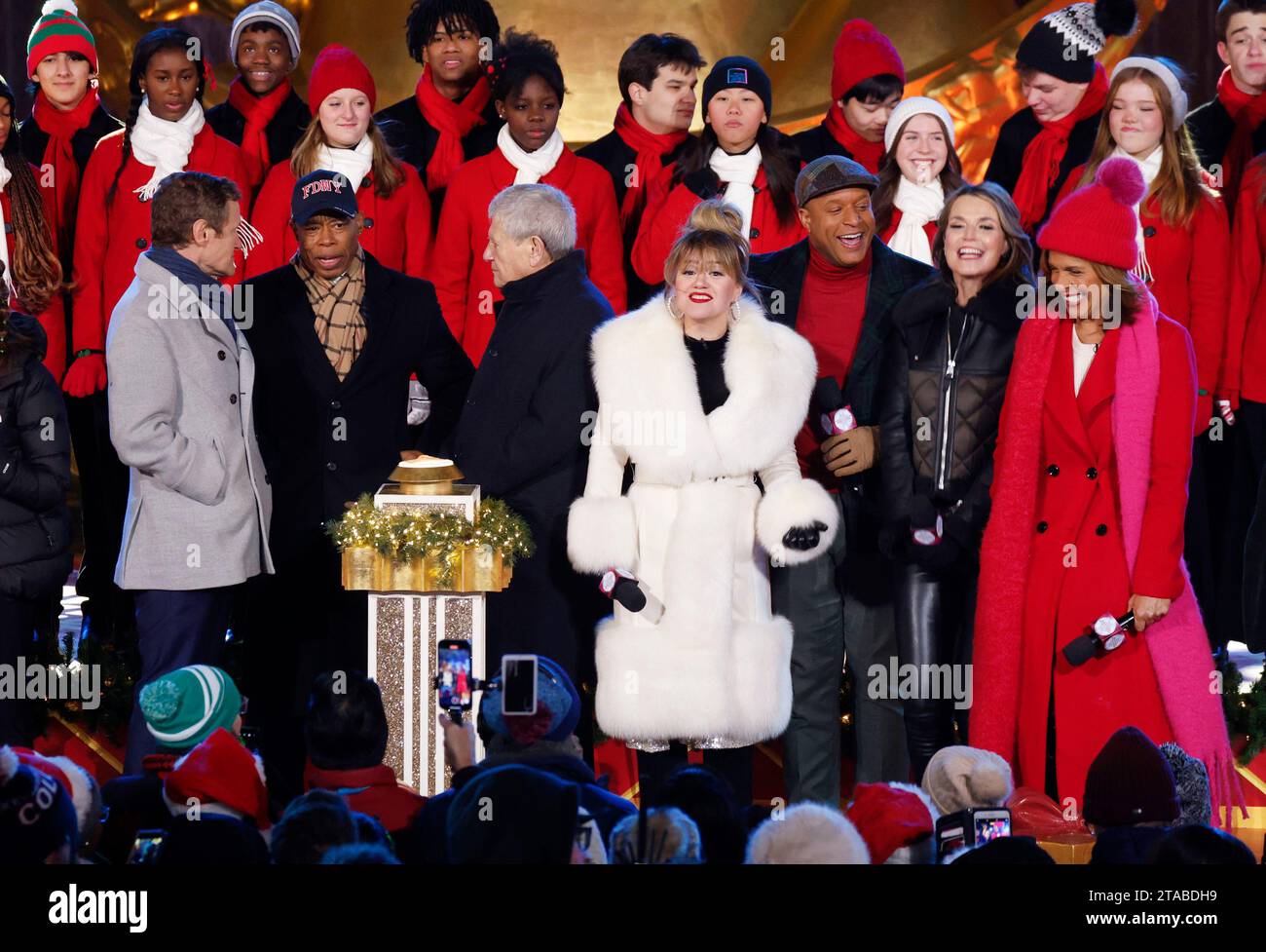 New York, United States. 29th Nov, 2023. President and Chief Executive Officer of Tishman Speyer, Rob Speyer, New York Mayor Eric Adams, Kelly Clarkson, Craig Melvin, Savannah Guthrie and Hoda Kotb light the stand on the stage at the 91st annual Rockefeller Center Christmas Tree Lighting Ceremony at Rockefeller Center in New York City on Wednesday, November 29, 2023. Photo by John Angelillo/UPI Credit: UPI/Alamy Live News Stock Photo