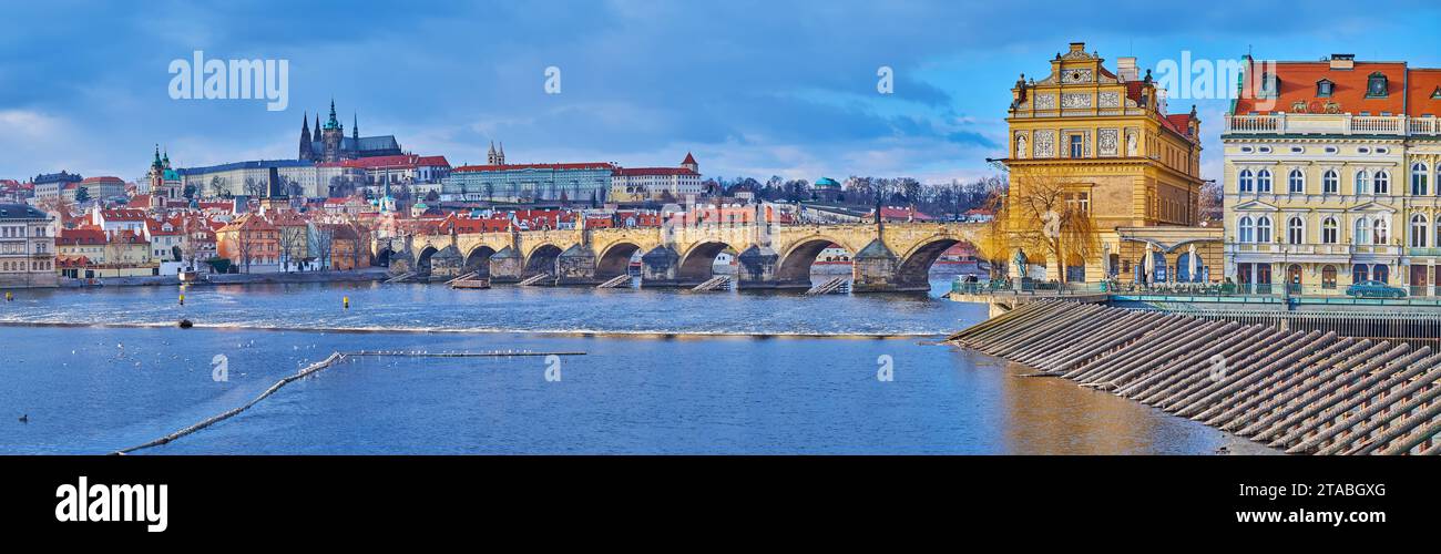 Panorama of Vltava River with medieval arched Charles Bridge, St Vitus Cathedral and Smetana Museum in historic mansion, covered with sgraffito, Pragu Stock Photo