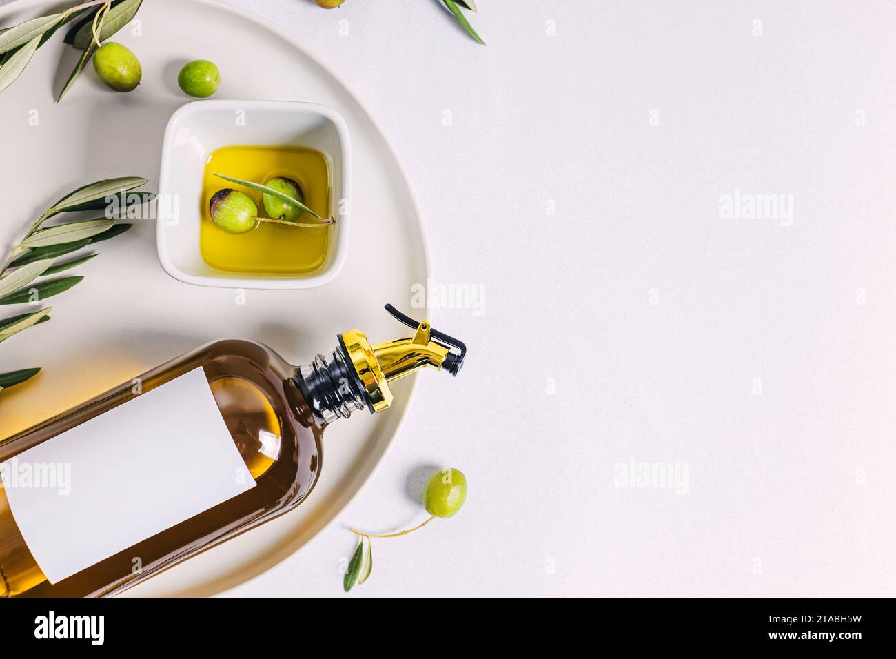 Olive oil in elegant bottle and olives, top view Stock Photo - Alamy