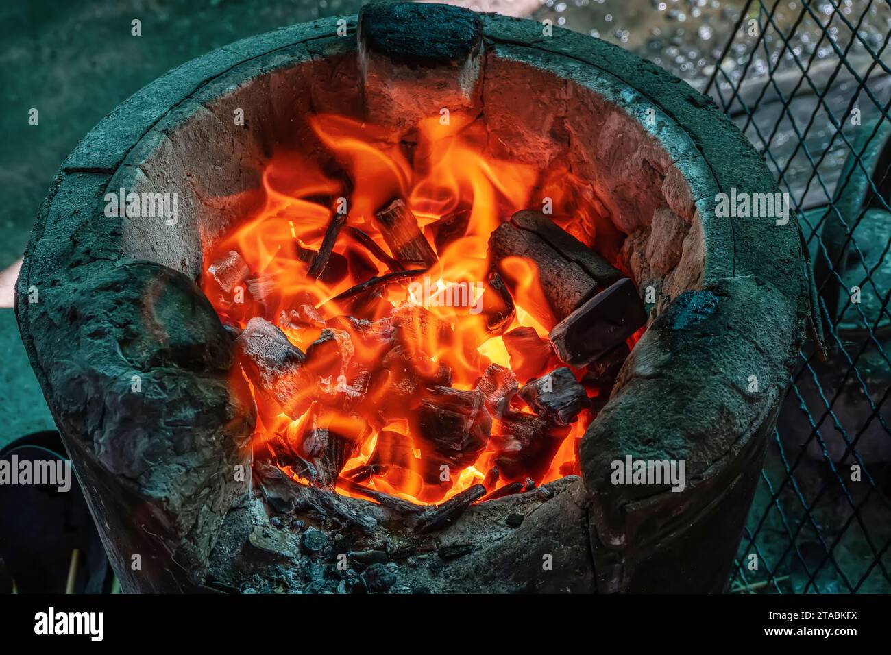 Charcoal brazier with burning charcoal is ready to use. It is also
