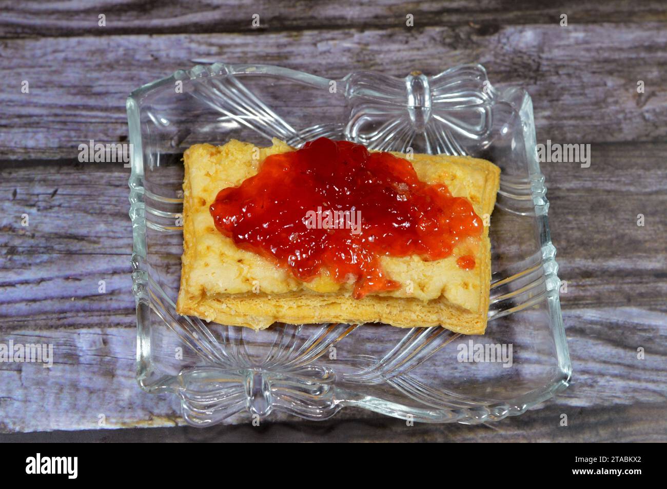 mille-feuille, millefeuille, Napoleon, vanilla and custard slice topped and covered with strawberry jam, a French dessert made of puff pastry layered Stock Photo
