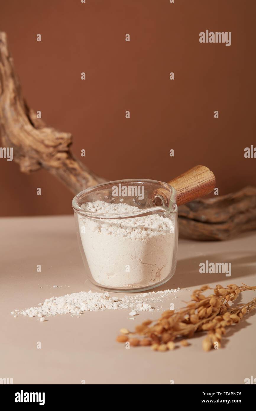 Rice bran powder stored in a glass bowl with a wooden handle. Lipids in