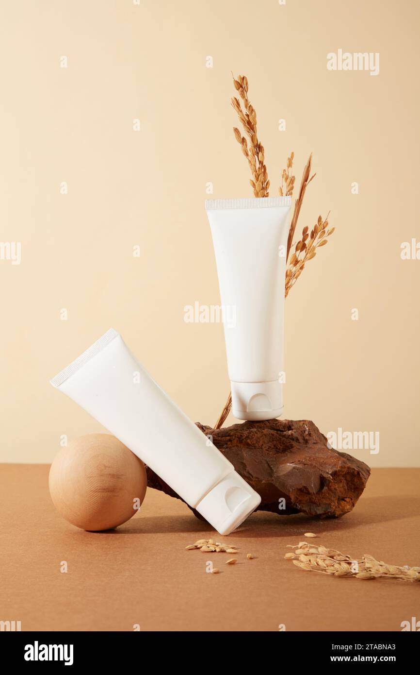 Two cosmetic tubes presented against a minimalist backdrop. Labels left