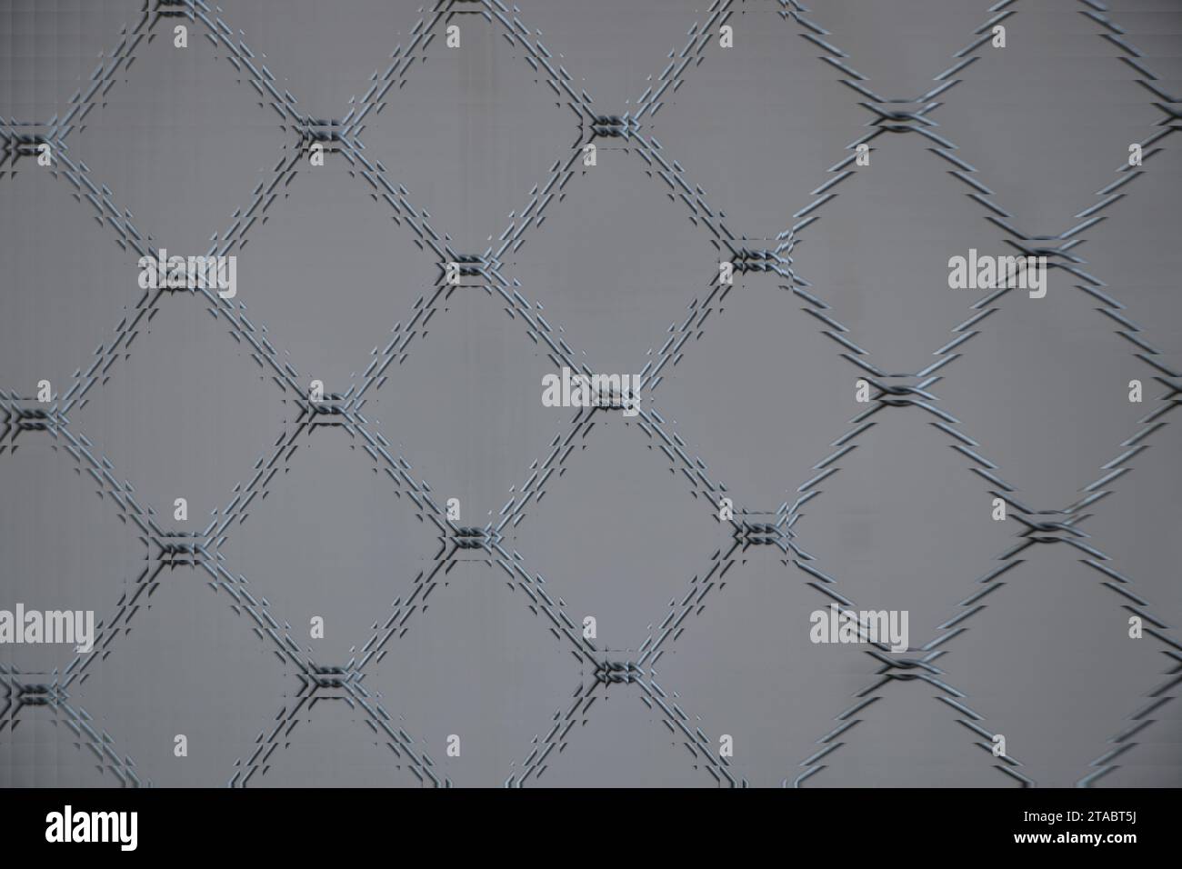 The abstract pattern background resembles a glass prism processed from a barbed wire fence image. Stock Photo