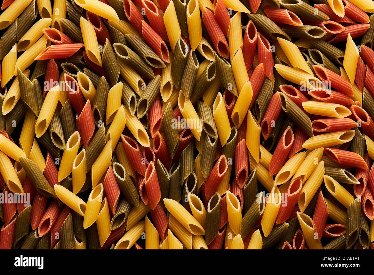 Abstract food background of assorted penne pasta varieties, copy space ...