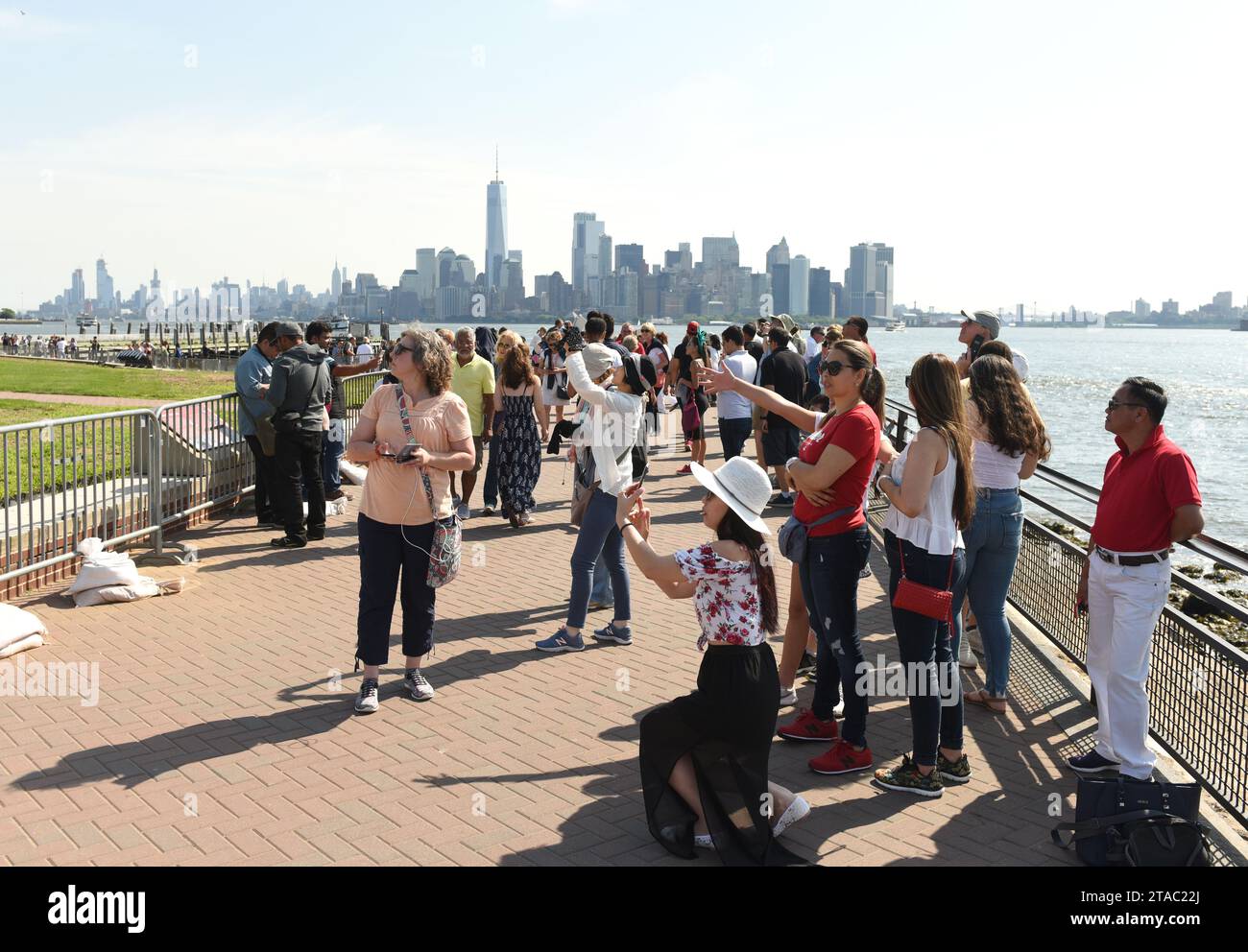 New York, USA - June 09, 2018: Crowd of people near the  Statue of Liberty. Stock Photo