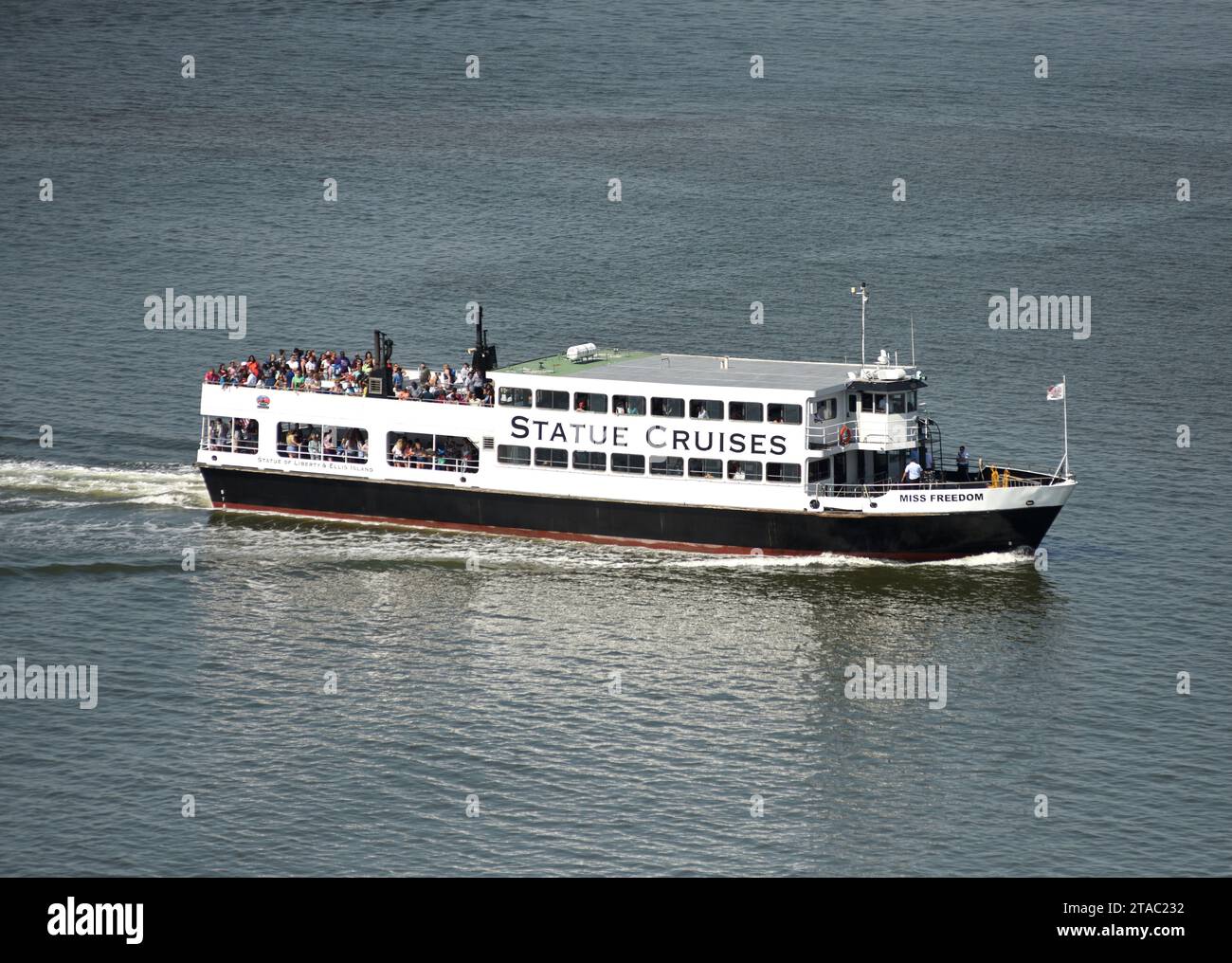 New York, USA - June 09, 2018: Ferry of Statue Cruises goes to the Statue of Liberty and  Ellis Island. Stock Photo